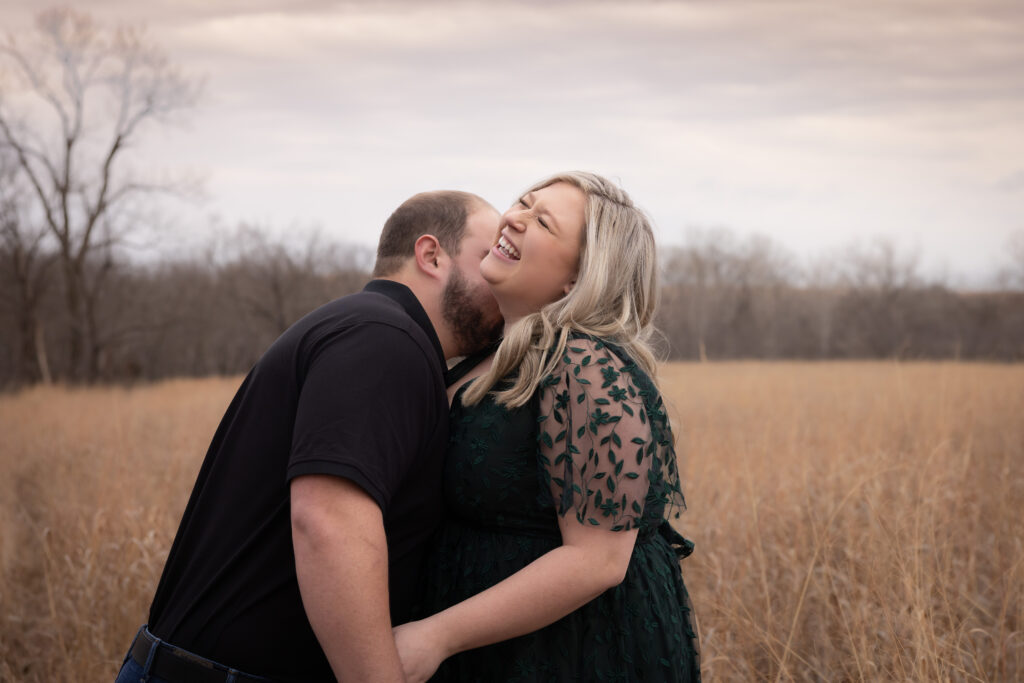 Kissing her neck and making her laugh