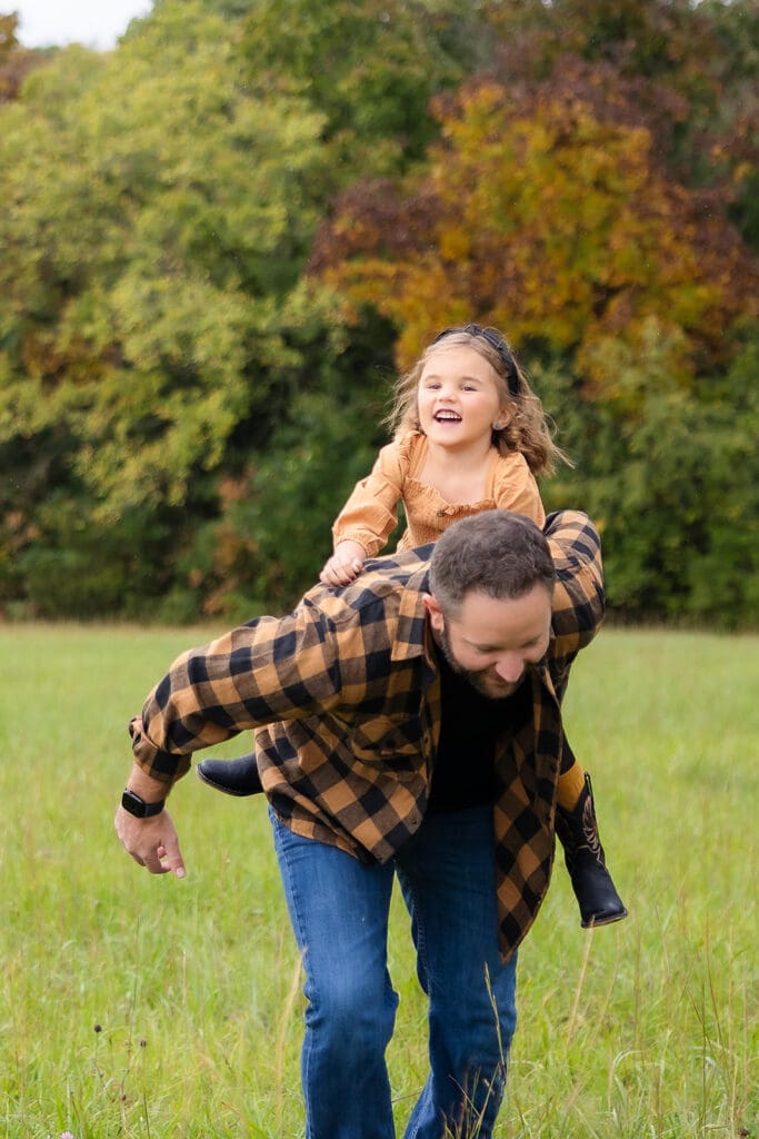 what to wear to a fall mini session Father and daughter playing and laughing