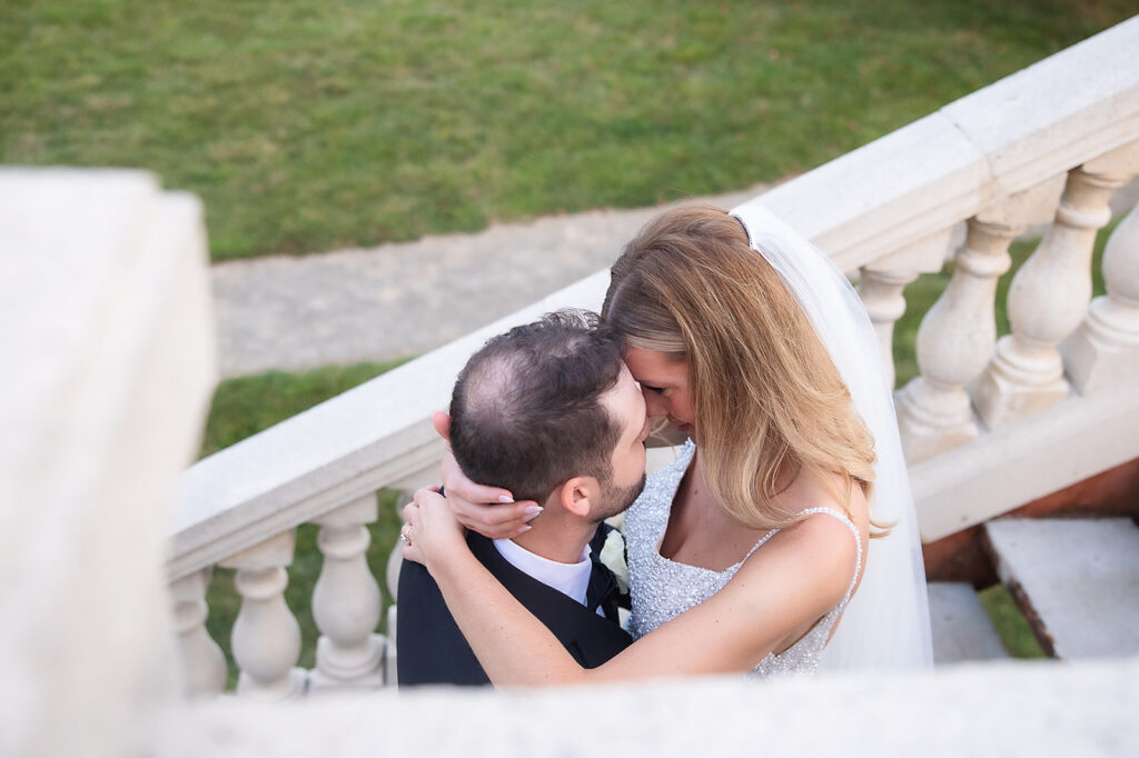 Bride and Groom forehead to forehead on stone stairs